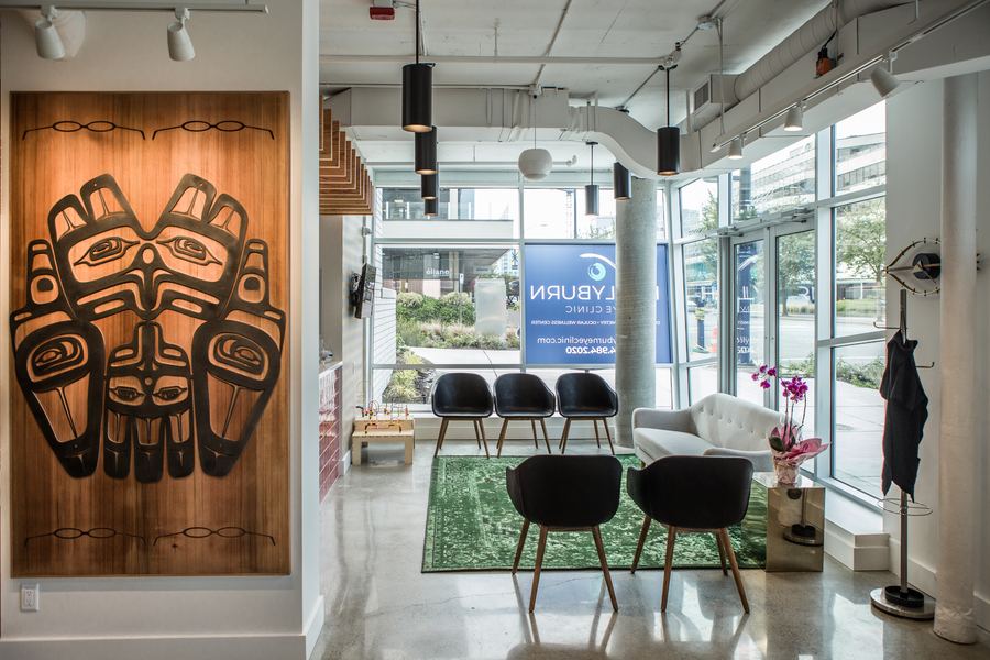 Hollyburn Eye Clinic — living moss wall with Hollyburn branding, cedar ceiling and green velvet seating